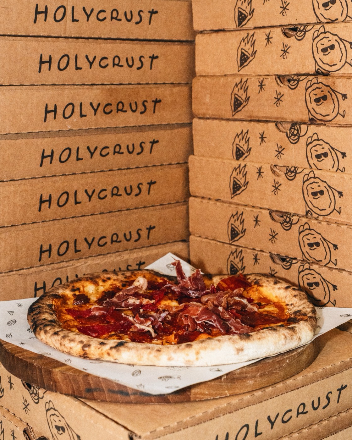 Stack of Holy Crust pizza boxes