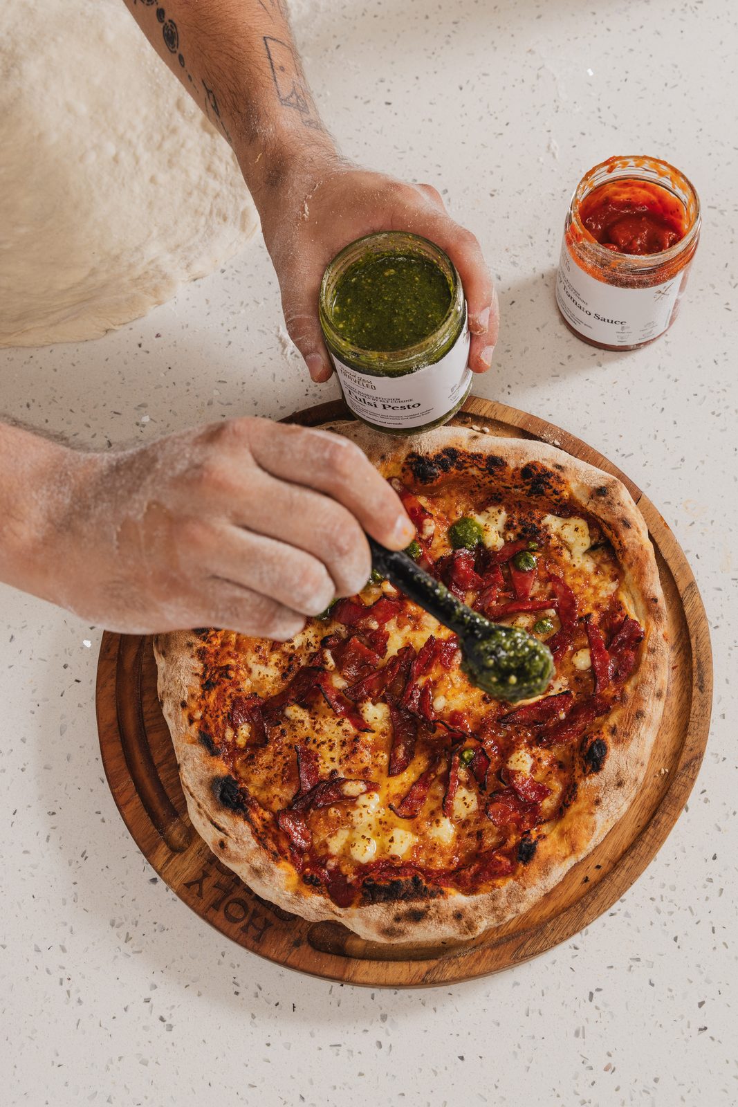 Herb oil poured over a finished Holy Crust pizza