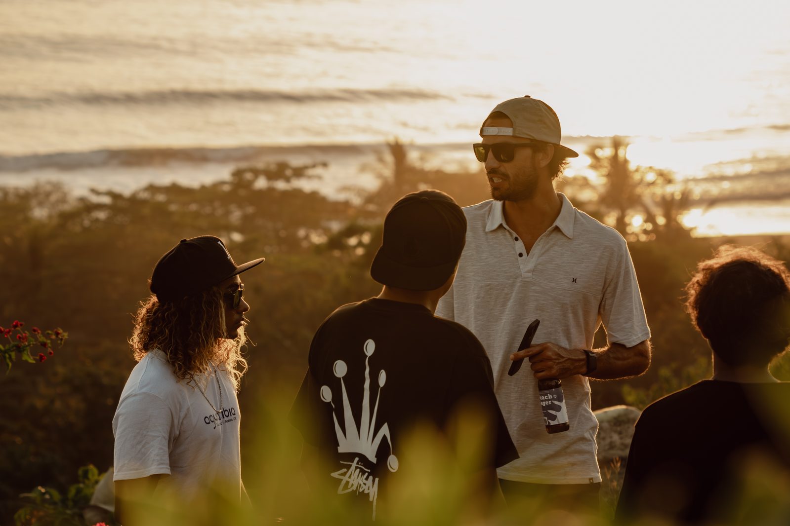 Guests talking at golden hour during a Holy Crust event