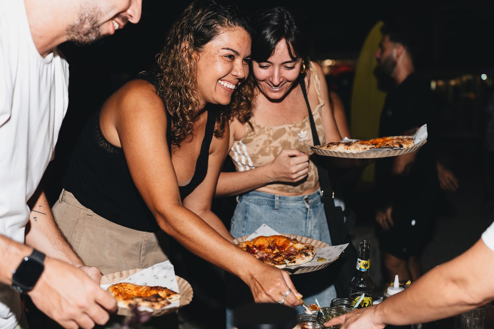 Two guests sharing a slice at a Holy Crust event