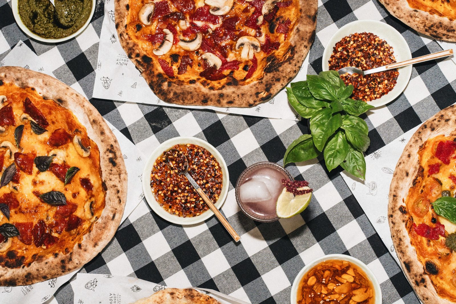 Branded Holy Crust pizza boxes stacked at an event