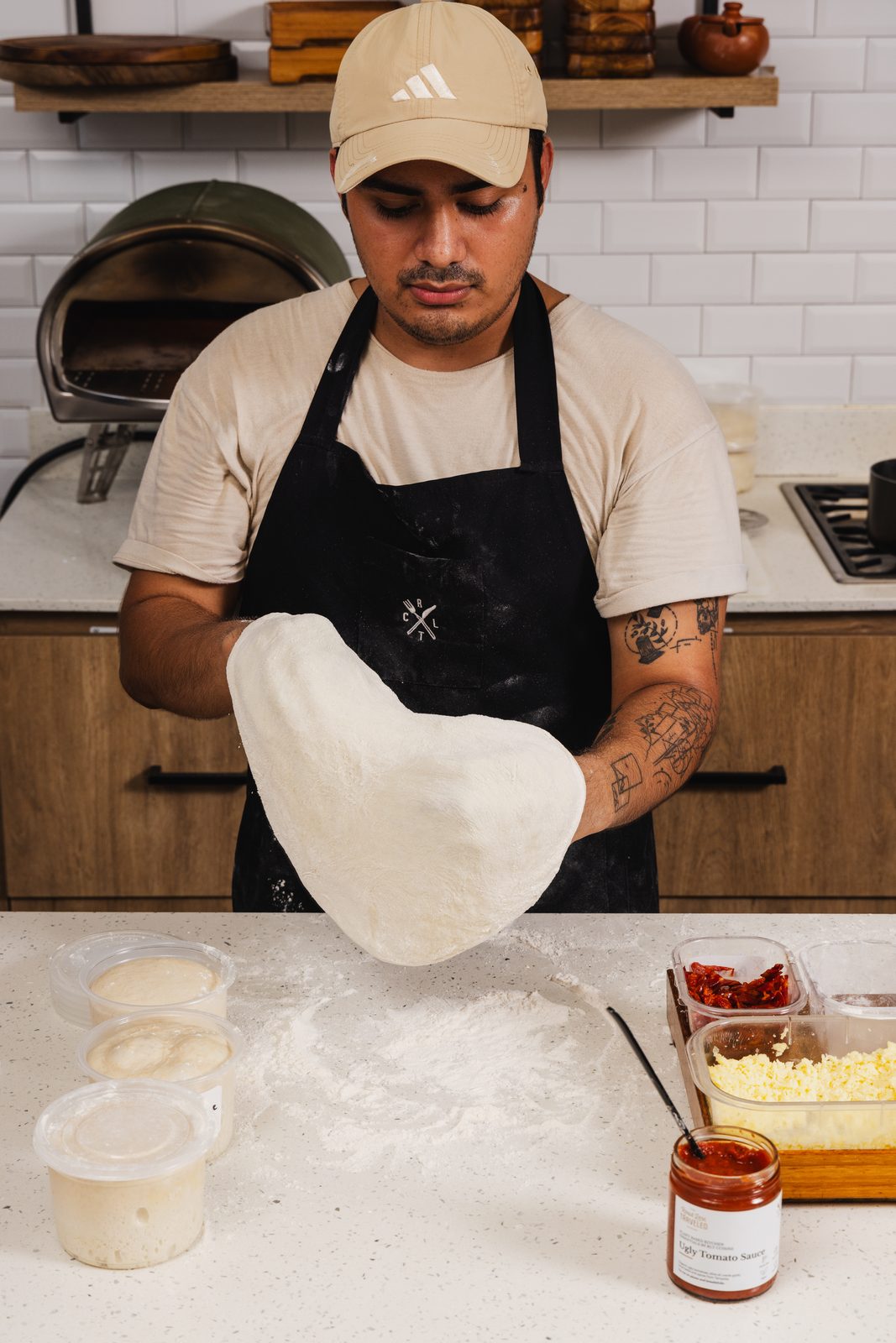 Stretching a ball of sourdough pizza dough by hand