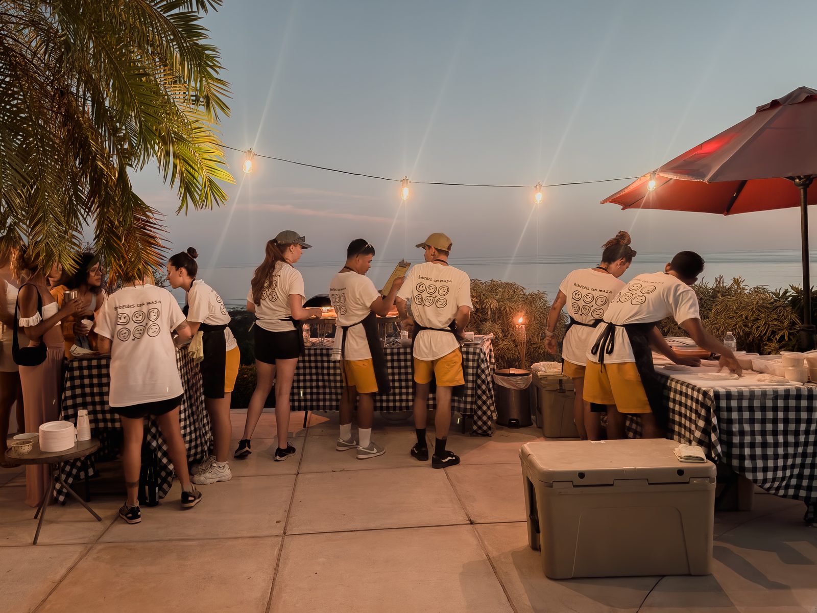 Holy Crust pizza station under string lights at an evening event in Guanacaste