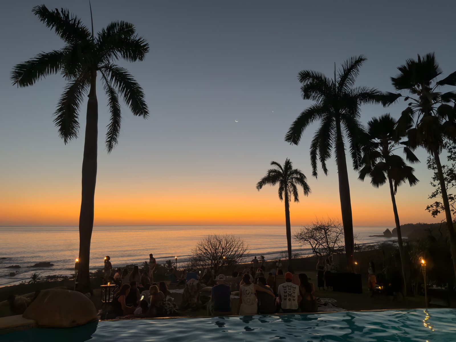 Palms and a Guanacaste venue at sunset before a Holy Crust event